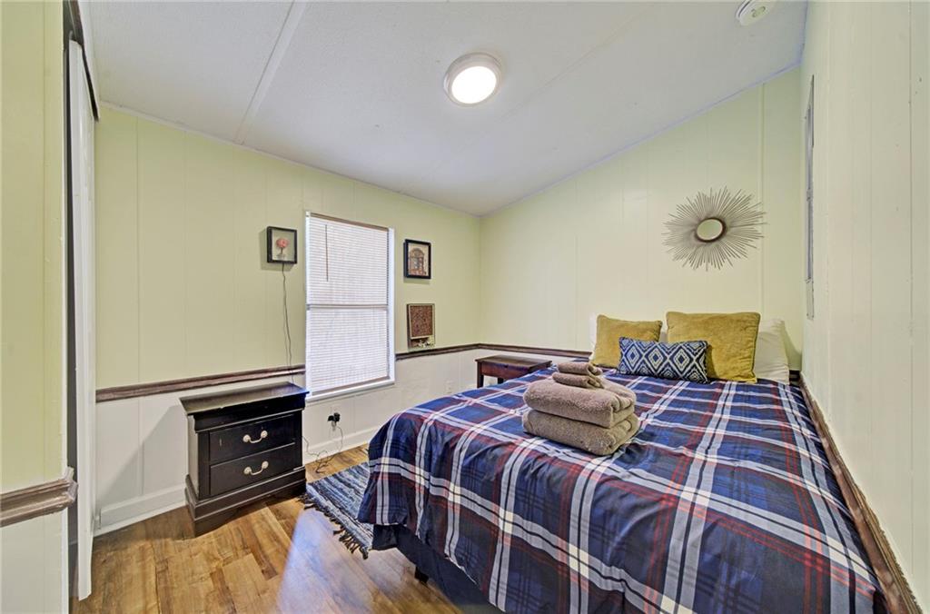 167 Jasmine Drive Ranger, GA 30734 - Photo 14 of 38 a bedroom with a bed and wooden floor