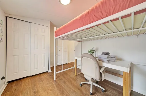 a workspace with wooden floor and furniture