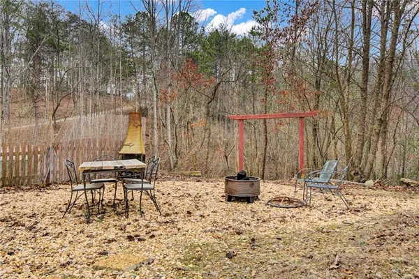 a backyard of a house with table and chairs