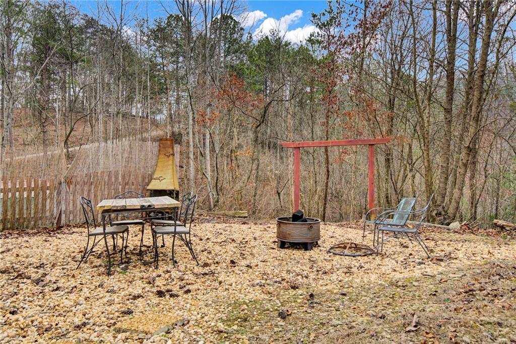 167 Jasmine Drive Ranger, GA 30734 - Photo 23 of 38 a backyard of a house with table and chairs