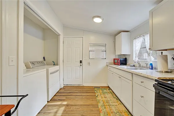 a room with white cabinets and sink