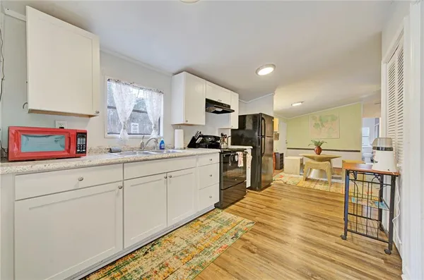 a kitchen with stainless steel appliances granite countertop a refrigerator sink and cabinets