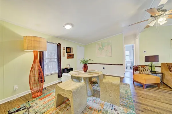 a living room with furniture and wooden floor