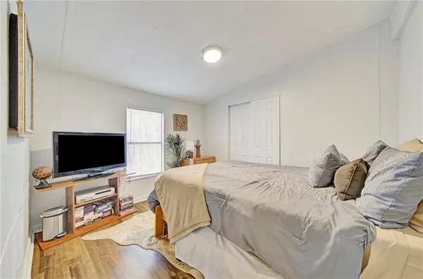 a bedroom with a bed and a flat screen tv
