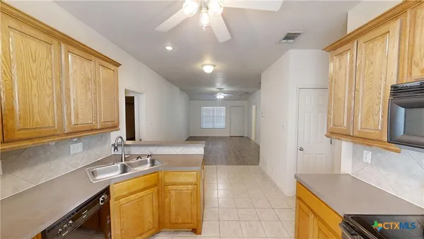 a spacious bathroom with a tub sink and mirror