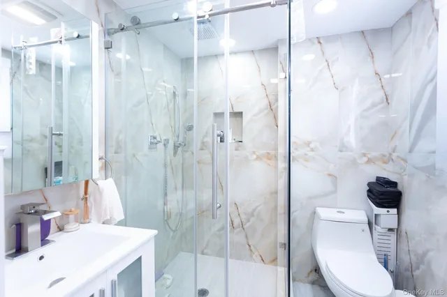 a bathroom with a sink toilet and shower