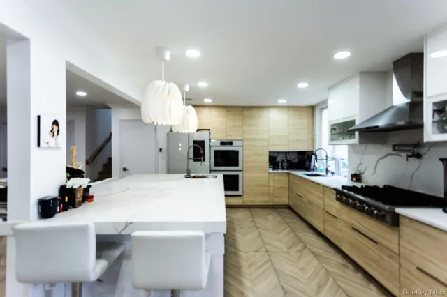 a large kitchen with a large counter top appliances and cabinets