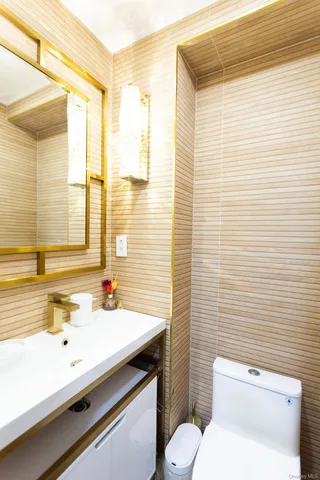 a bathroom with a sink a toilet and a mirror