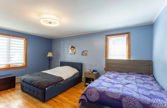 a bedroom with two beds and a window