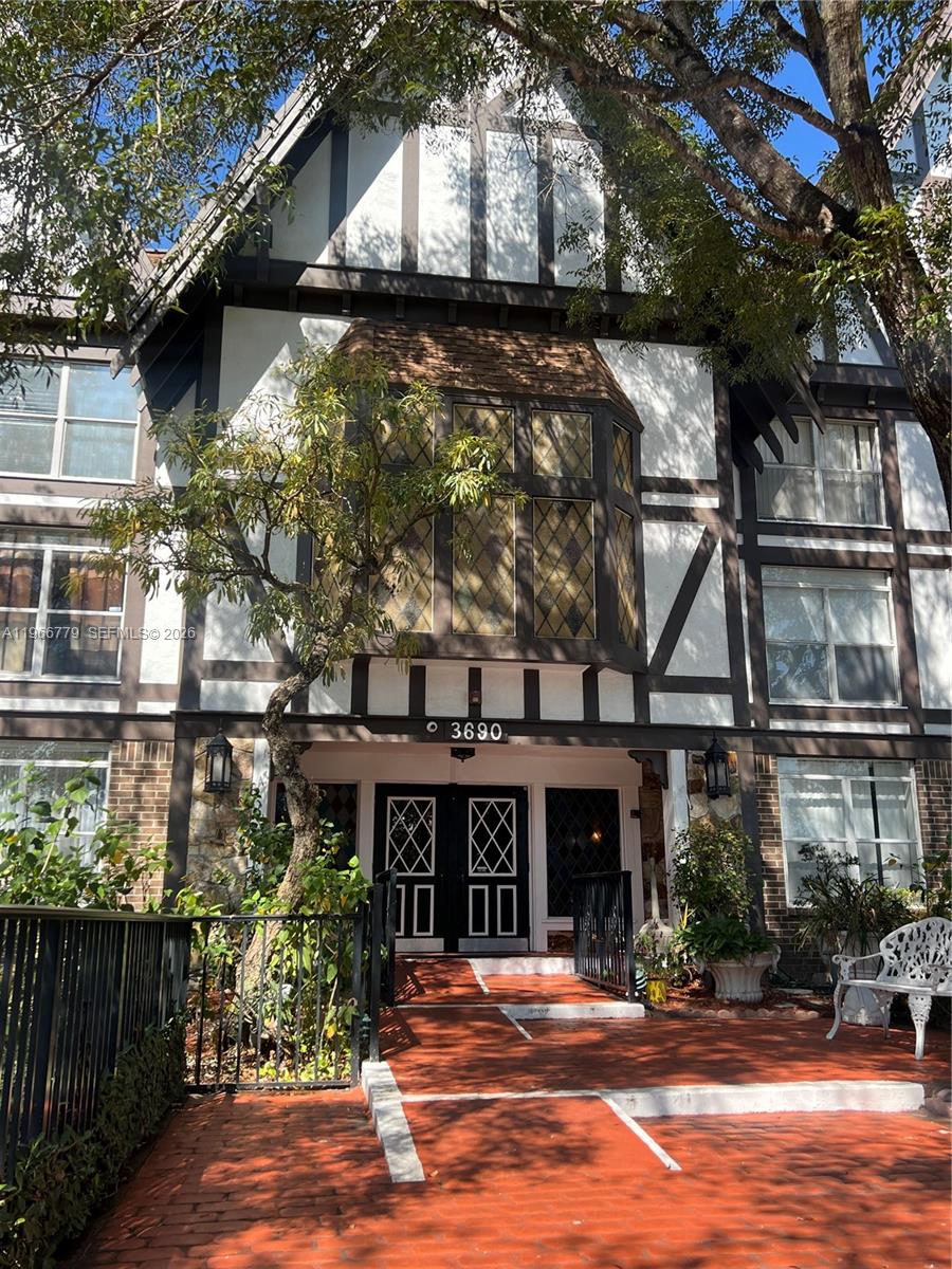 a front view of a building with a garden