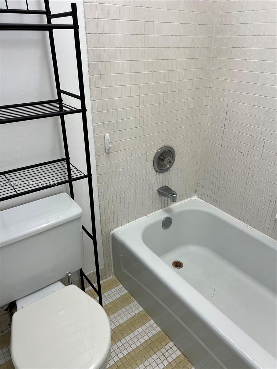 3690 Inverrary Drive, Unit 1K Lauderhill, FL 33319 - Photo 14 of 34 a bathroom with a bathtub and toilet
