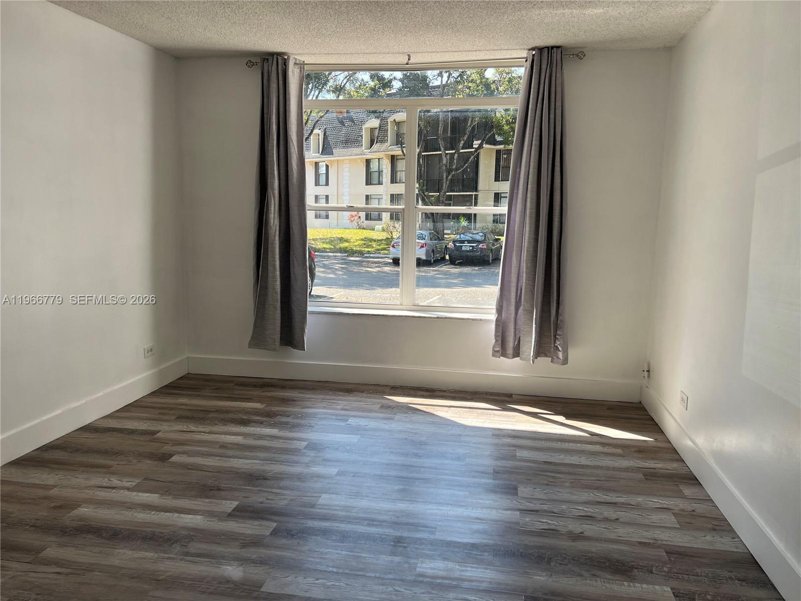 3690 Inverrary Drive, Unit 1K Lauderhill, FL 33319 - Photo 17 of 34 a view of wooden floor and chandelier in a room