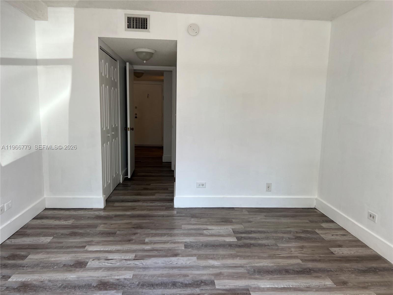 3690 Inverrary Drive, Unit 1K Lauderhill, FL 33319 - Photo 20 of 34 a view of an empty room with wooden floor