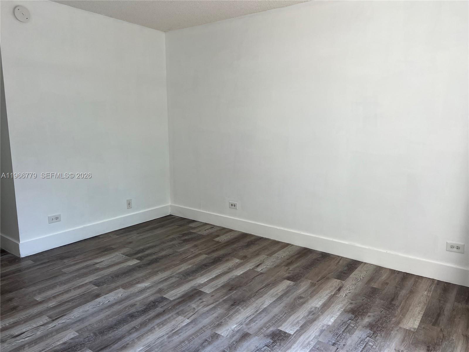 3690 Inverrary Drive, Unit 1K Lauderhill, FL 33319 - Photo 21 of 34 a view of an empty room with wooden floor