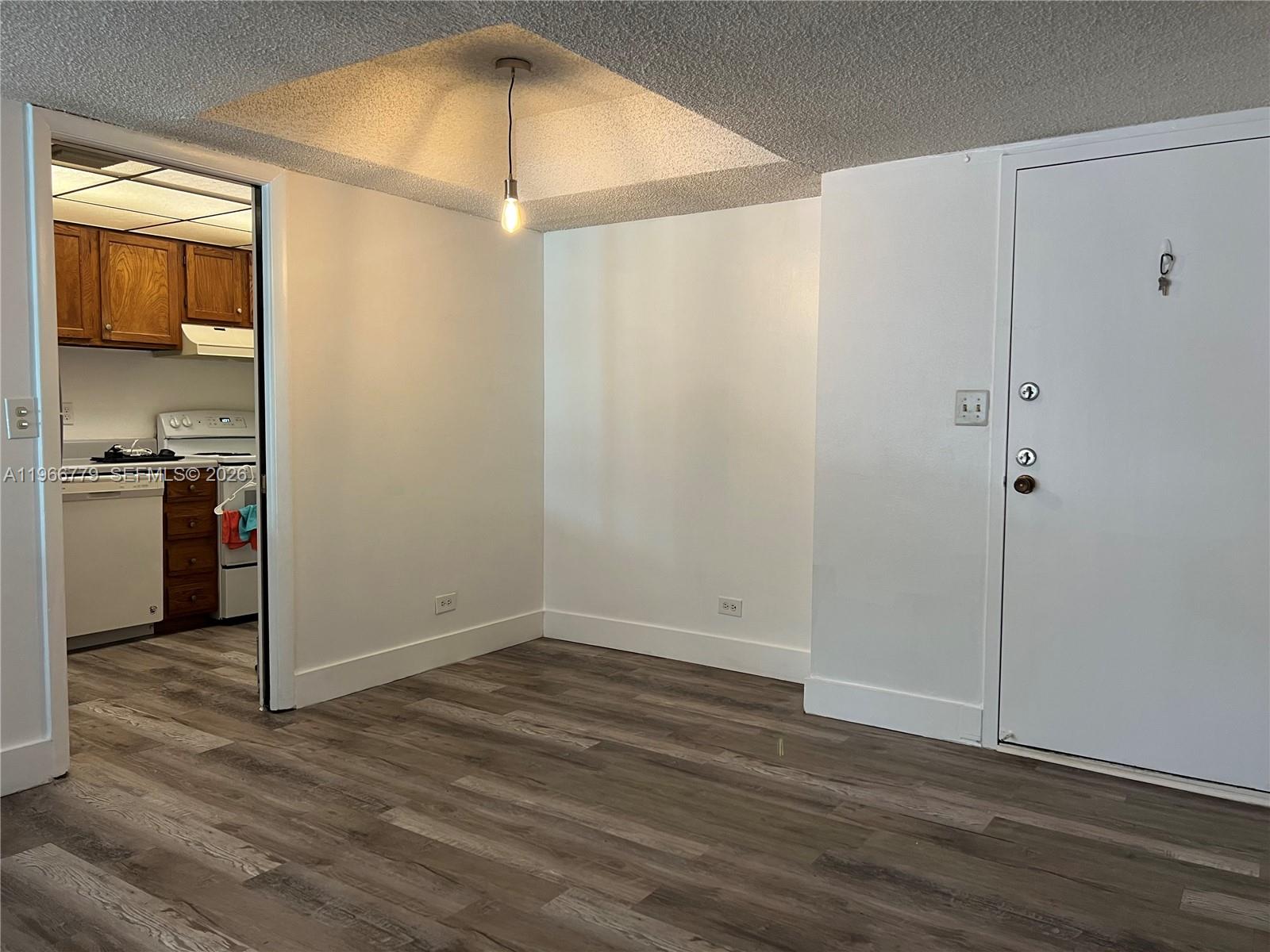 3690 Inverrary Drive, Unit 1K Lauderhill, FL 33319 - Photo 24 of 34 a view of empty room with wooden floor and fan