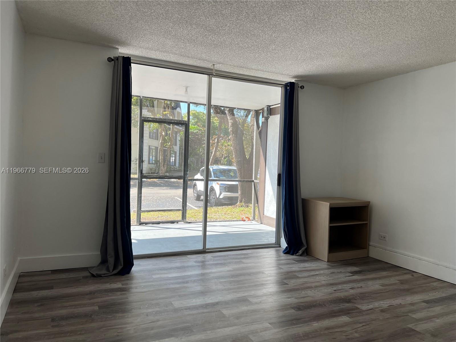 3690 Inverrary Drive, Unit 1K Lauderhill, FL 33319 - Photo 28 of 34 a view of an empty room with wooden floor and a window