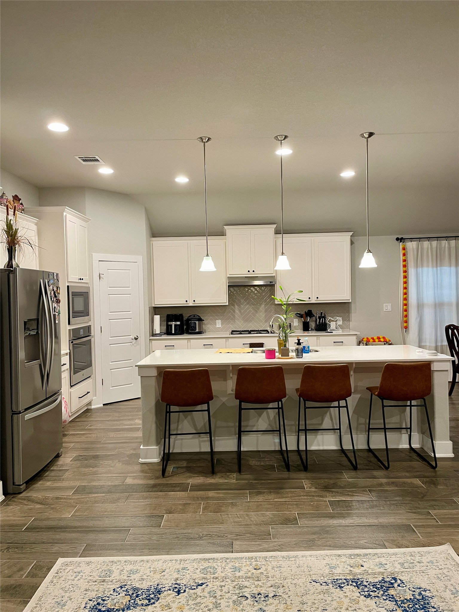 120 Sail Wind Way Georgetown, TX 78633 - Photo 5 of 25 a kitchen with kitchen island stainless steel appliances a dining table and chairs