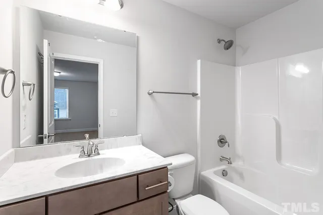 a bathroom with a sink toilet tub and shower