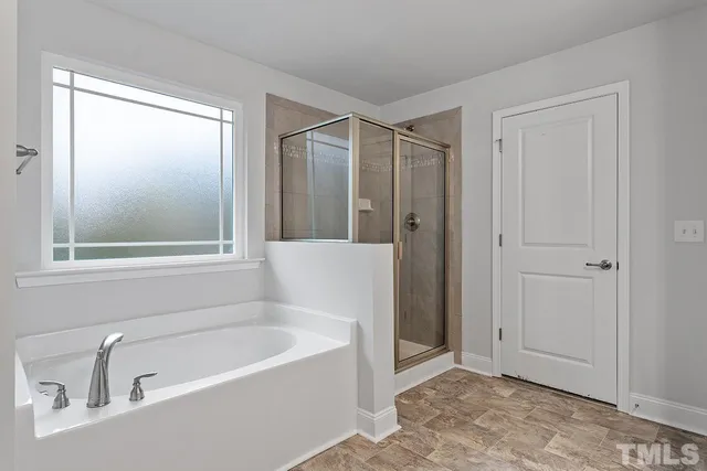 a white bath tub sitting next to a window