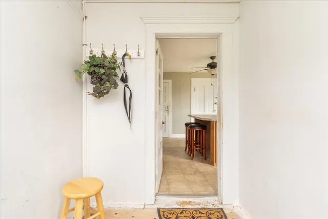 a view of a hallway with seating area