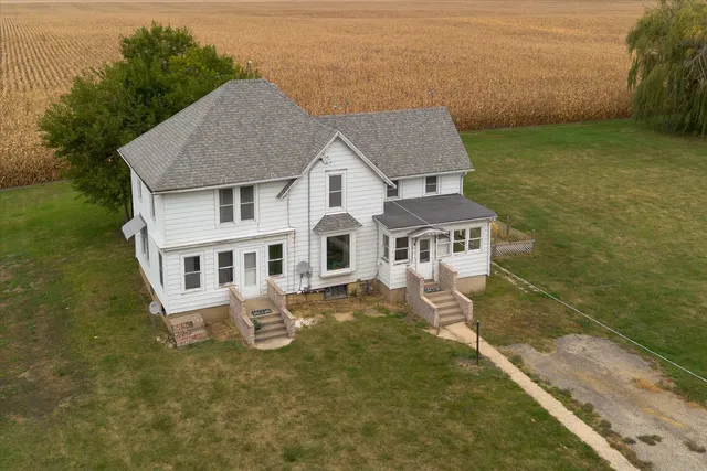 an aerial view of a house with a yard table and chairs