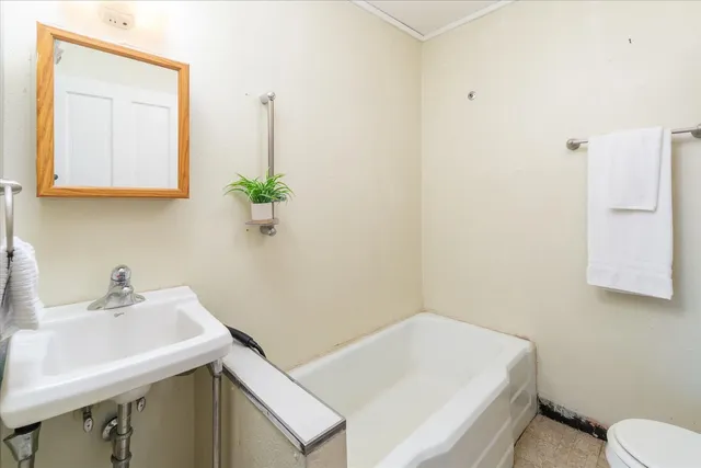 a bathroom with a sink a toilet and a mirror