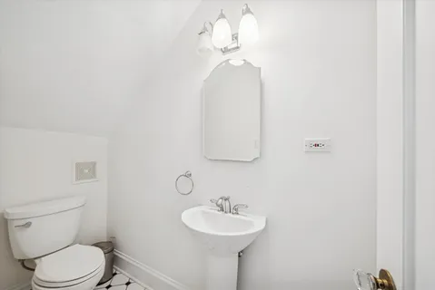 a bathroom with a sink a toilet and a mirror