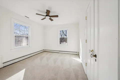 an empty room with windows and closet
