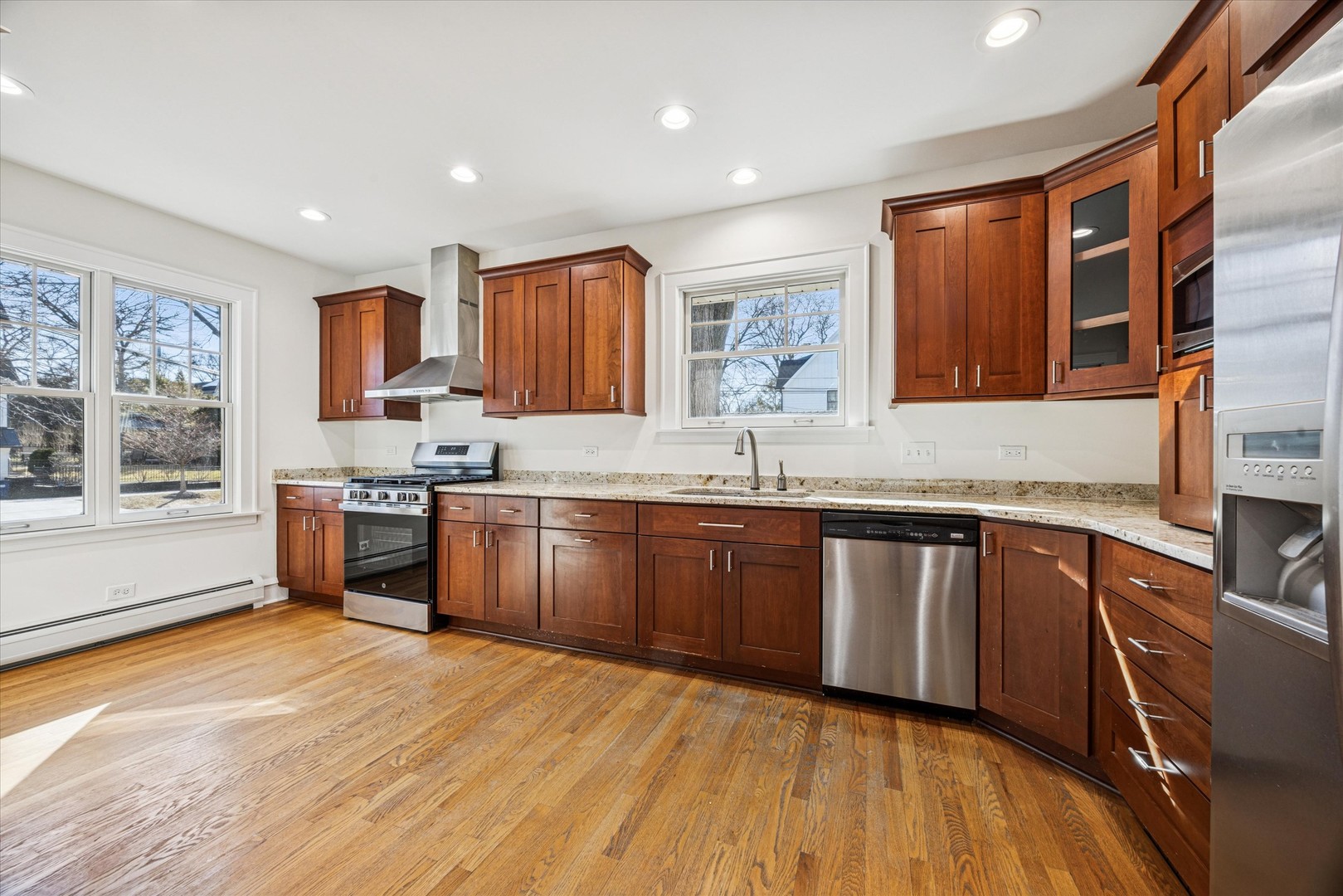 3946 Howard Avenue Western Springs, IL 60558 - Photo 10 of 28 a kitchen with stainless steel appliances granite countertop a sink stove and wooden cabinets