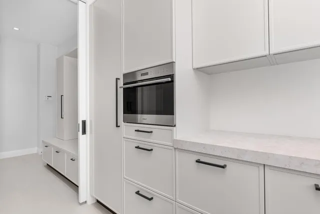 a view of a dining room with furniture a chandelier and wooden floor