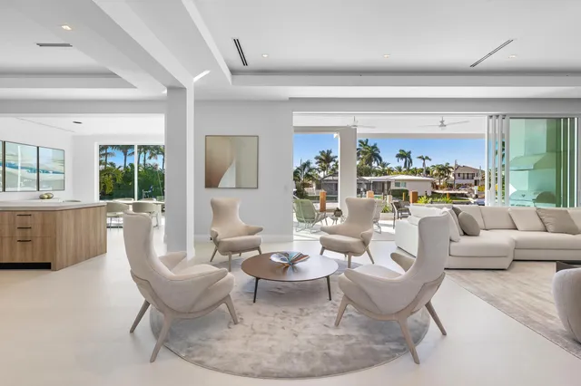 a living room with stainless steel appliances kitchen island a large window