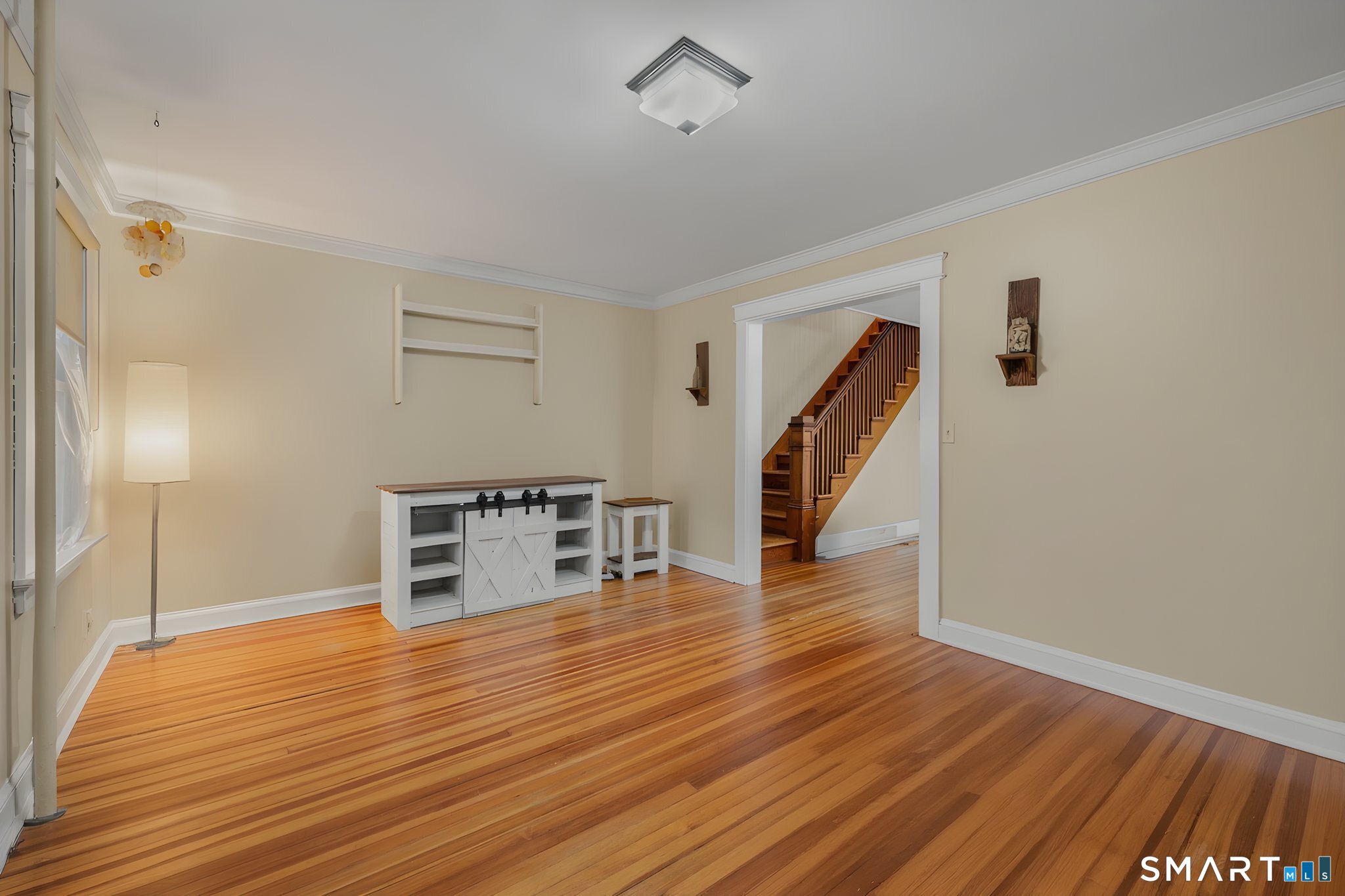 414 Main Street Sprague, CT 06330 - Photo 11 of 34 a view of a livingroom with wooden floor and stairs