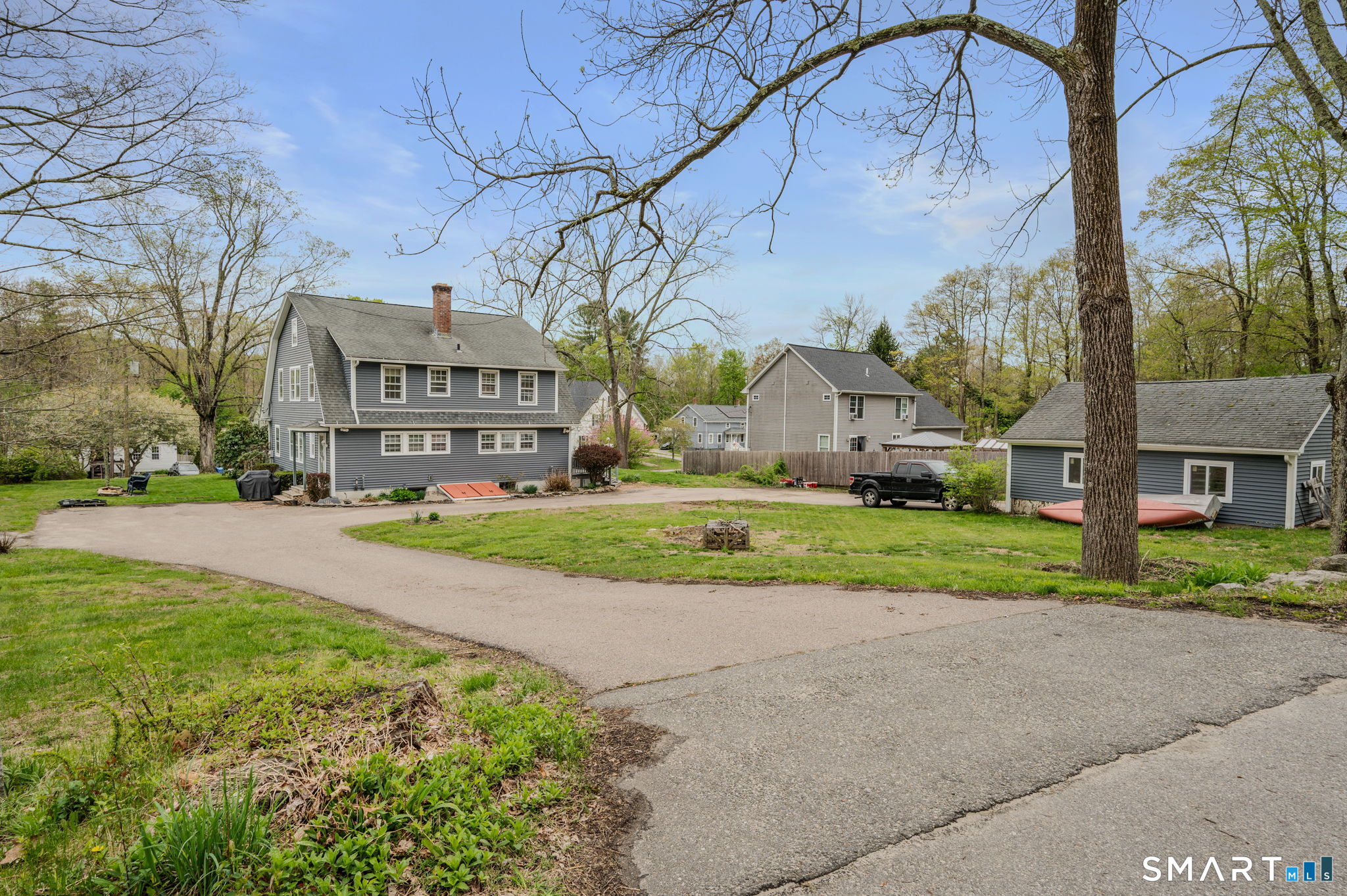414 Main Street Sprague, CT 06330 - Photo 2 of 34 a view of house with a big yard and large trees