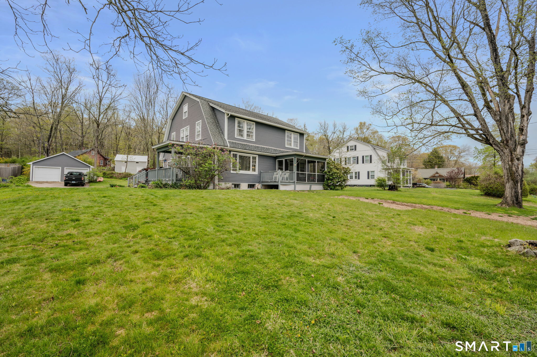 414 Main Street Sprague, CT 06330 - Photo 4 of 34 a view of a house with a big yard and large trees