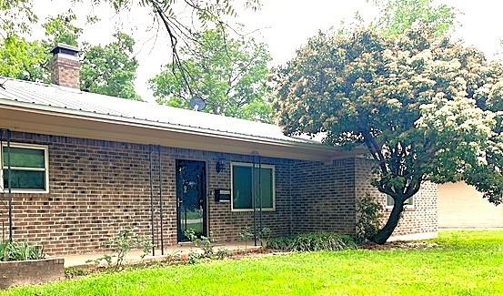 a view of house with yard