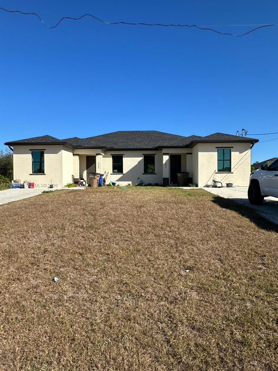 4660-4662 26th Street Southwest Lehigh Acres, FL 33973 - Photo 1 of 22 a large house with a yard