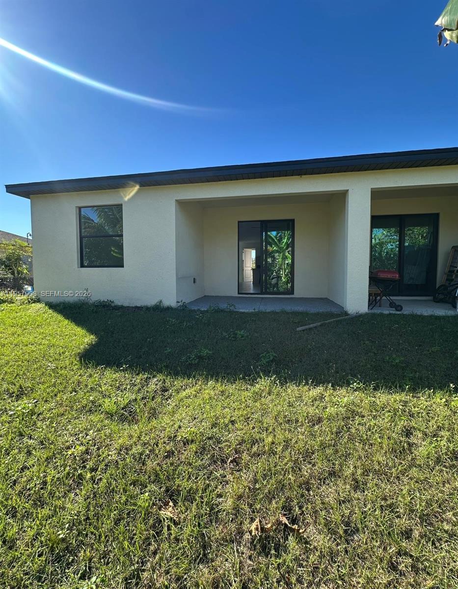 4660-4662 26th Street Southwest Lehigh Acres, FL 33973 - Photo 12 of 22 a front view of a house with a yard