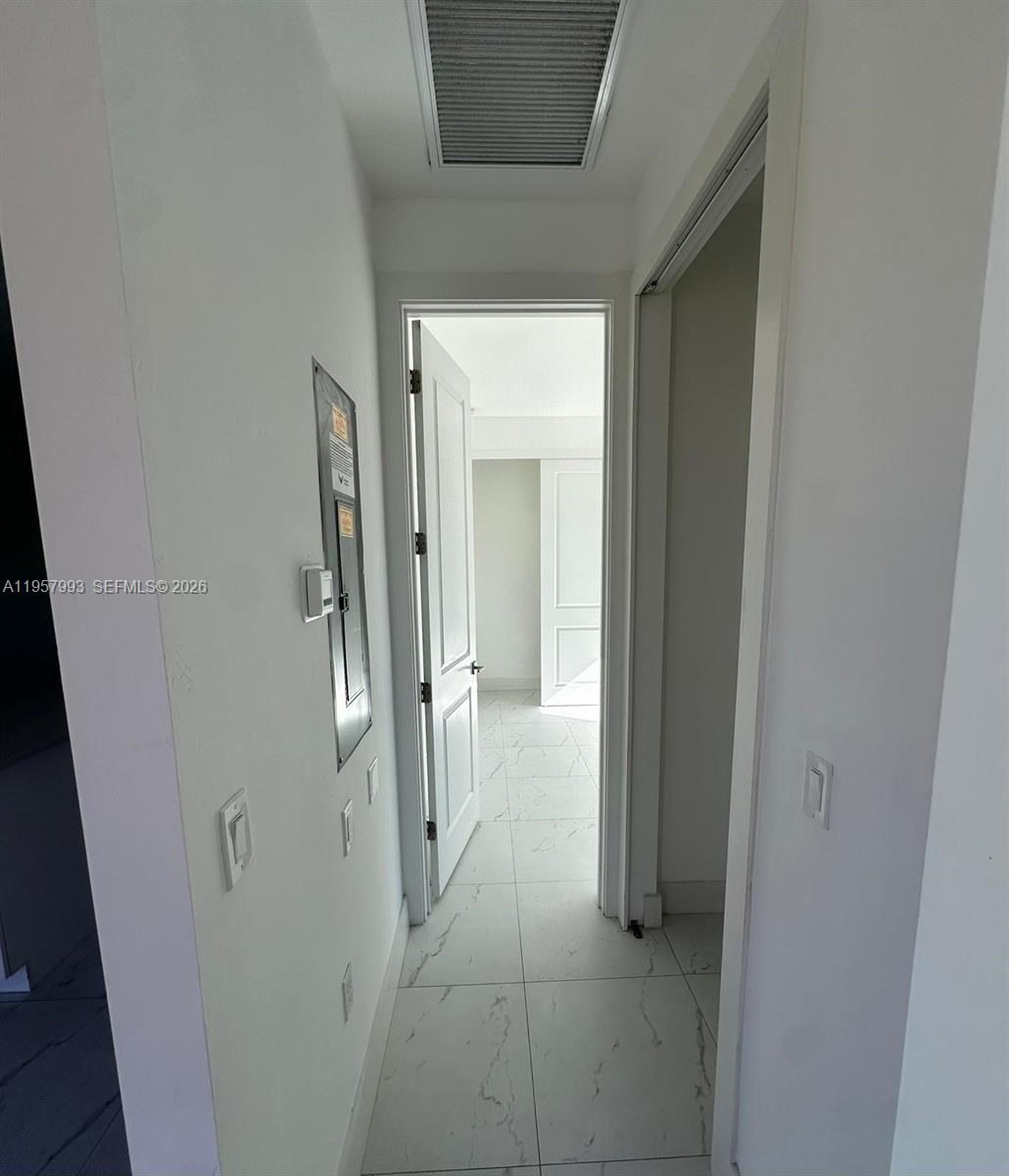 4660-4662 26th Street Southwest Lehigh Acres, FL 33973 - Photo 20 of 22 a view of a hallway with a glass door