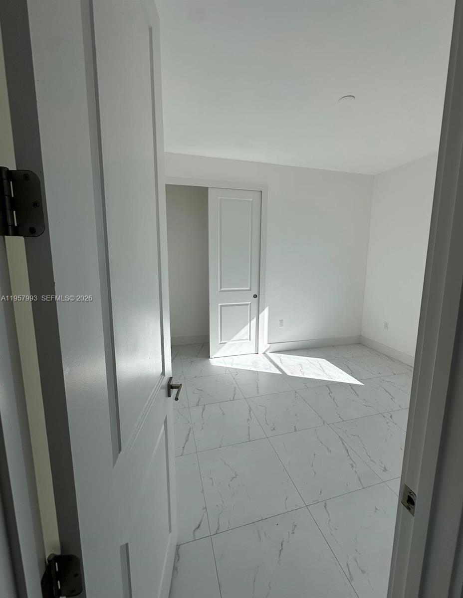 4660-4662 26th Street Southwest Lehigh Acres, FL 33973 - Photo 21 of 22 an empty room with windows