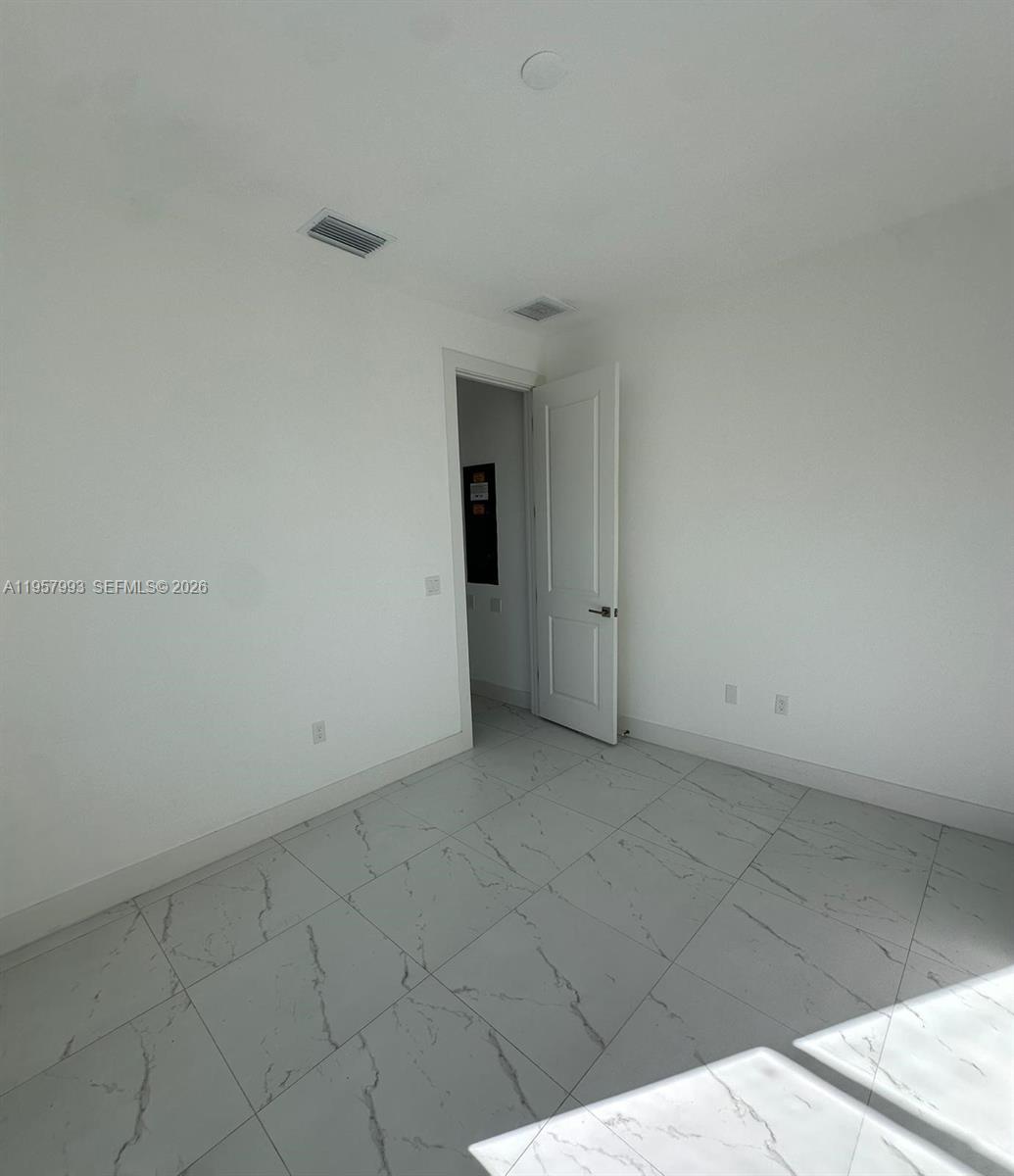 4660-4662 26th Street Southwest Lehigh Acres, FL 33973 - Photo 22 of 22 an empty room with an entryway