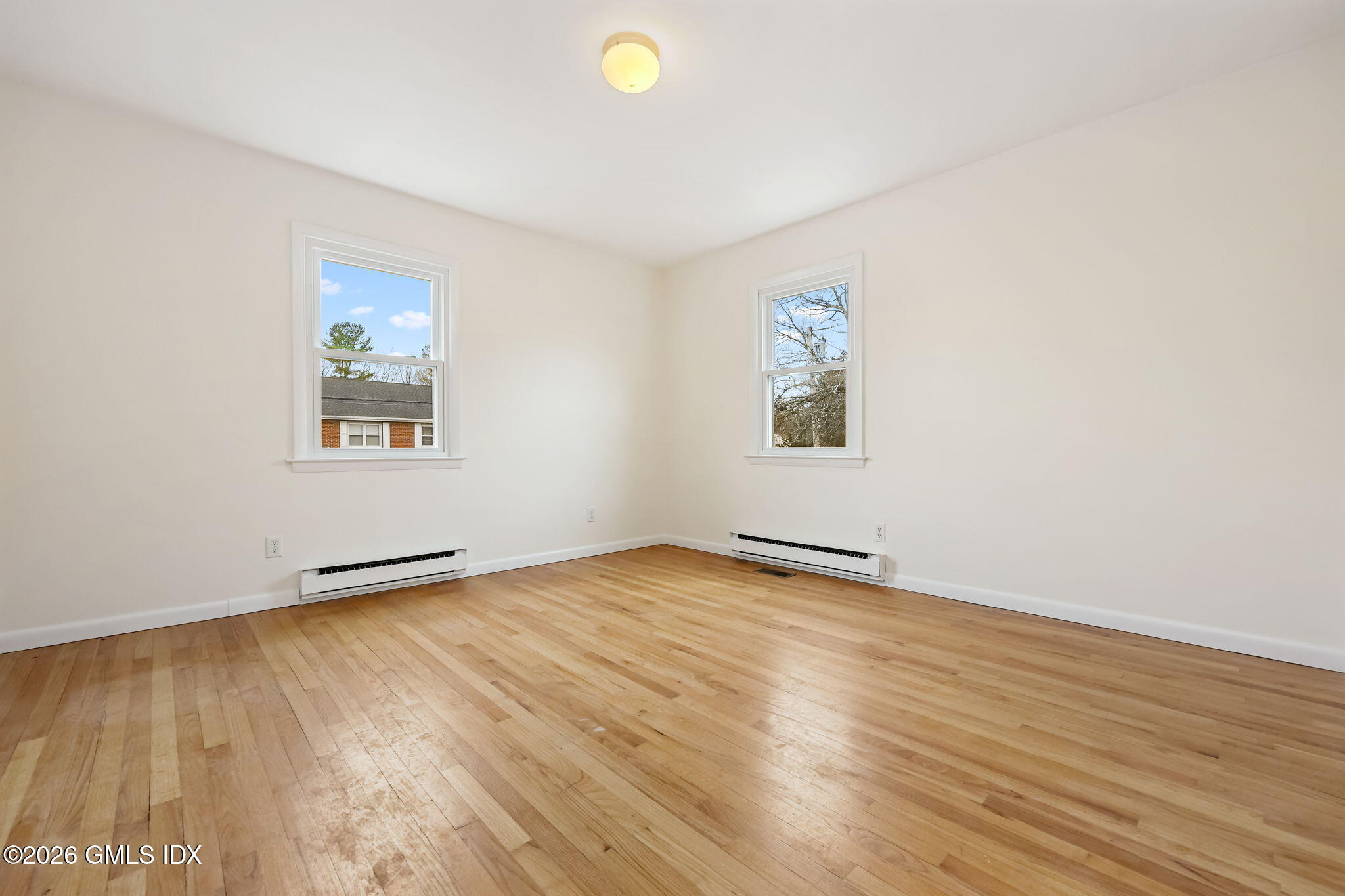 2 Grange Street Greenwich, CT 06830 - Photo 9 of 31 an empty room with wooden floor and windows