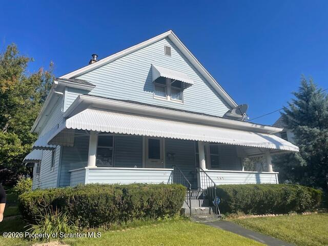 a view of house with outdoor space and garden