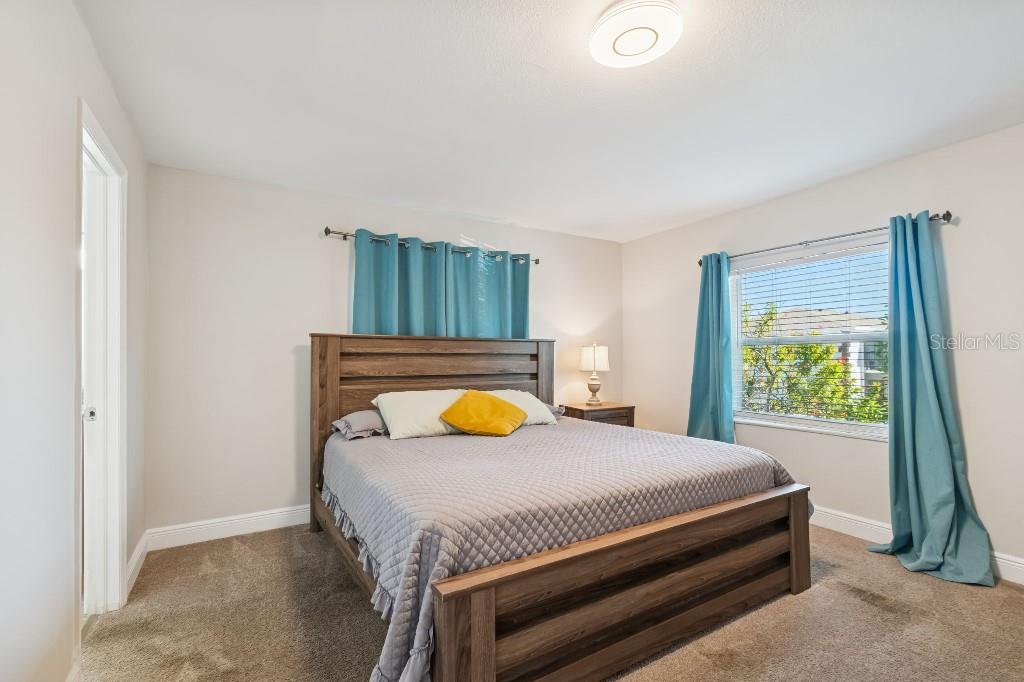 13125 Wilcox Road, Unit 6205 Largo, FL 33774 - Photo 26 of 48 a bedroom with a bed and a window