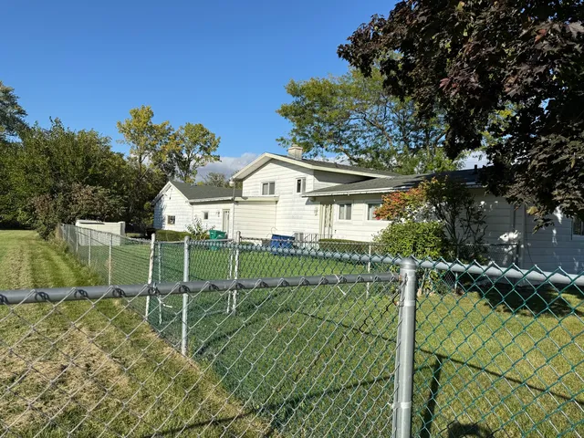 a view of a house with a yard and plants