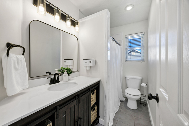 892 East 400 South Smithfield, UT 84335 - Photo 17 of 44 Main Full bathroom featuring vanity, a shower with curtain, light tile patterned floors, and recessed lighting