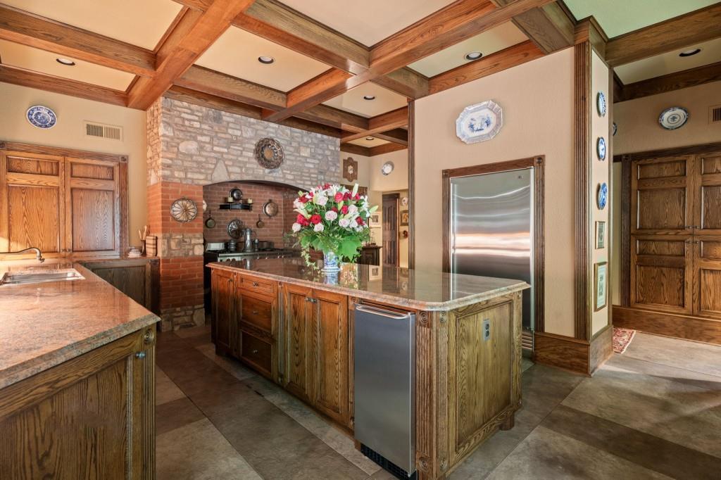 114 Lees Lake Road Fayetteville, GA 30214 - Photo 19 of 69 a kitchen with stainless steel appliances kitchen island granite countertop a table and chairs in it