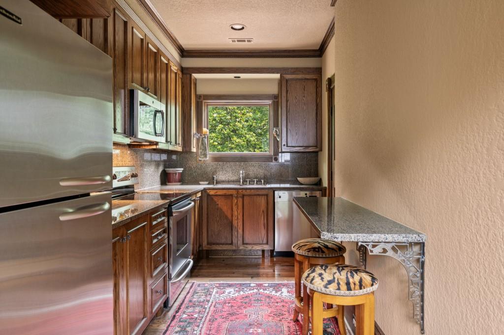 114 Lees Lake Road Fayetteville, GA 30214 - Photo 28 of 69 a kitchen with a stove a sink and a window