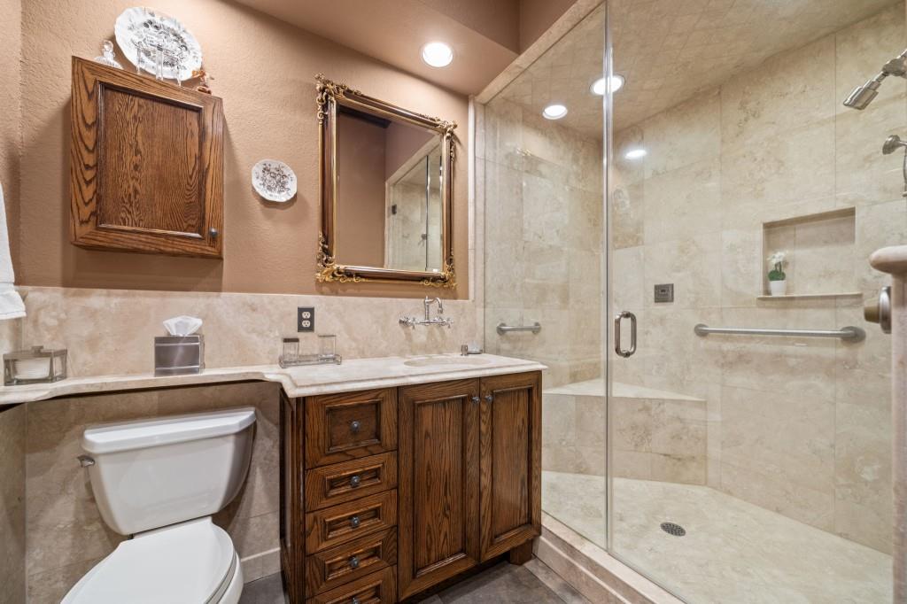 114 Lees Lake Road Fayetteville, GA 30214 - Photo 41 of 69 a bathroom with a toilet a sink a mirror and a shower