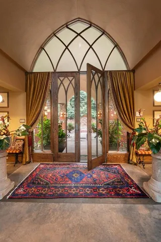 a kitchen with stainless steel appliances kitchen island granite countertop a table and chairs in it