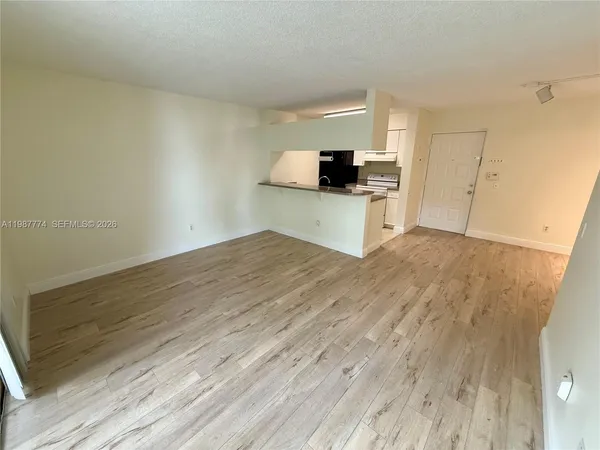 a view of kitchen with microwave oven and cabinets